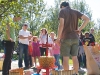 Enthusiastic parents and children enjoy a cider-making demonstration.