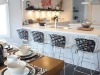 Fashionable chairs give this simple kitchen a dash of femininity and glamour. Photo By David Gillespie 