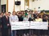 Teachers and students from Leadership Classes present Marc Kielburger with two enormous cheques.