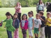 Children wait for their turn to hit the piñata.