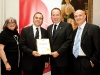 Vaughan Mayor Maurizio Bevilacqua presents a congratulatory certificate to Safehaven CEO Beverly Gordon, gala chair Tony Zingaro, and Board of Directors president Val Hortiguela. Photo by AYMPhotography.