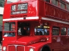 A London Bus roars down the street past Trafalgar Square.